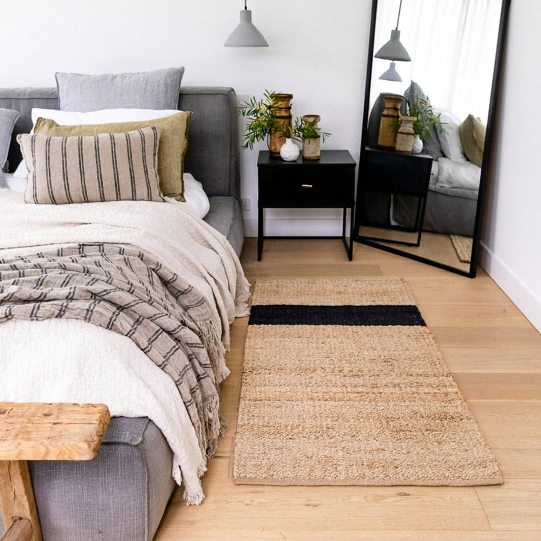 Modern bedroom with a bed, nightstands, and a rug.